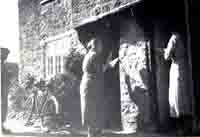 Mrs Ward and Mrs Thorner braiding at their cottage doors