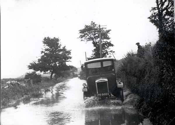 Old truck going through a flood