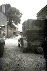 Two old cars in the lane