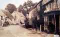 Two people outside cottage C. 1920