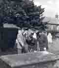 Common culture? Rector showing old gravestone