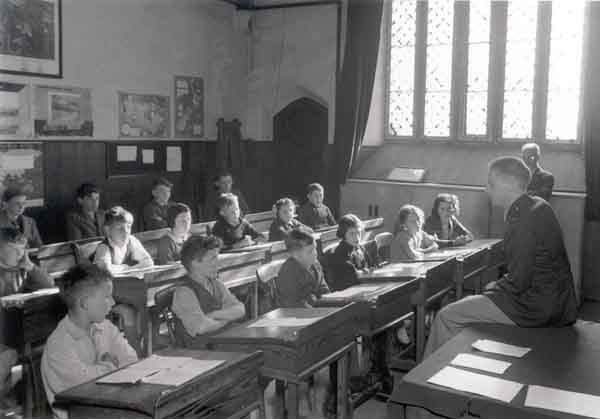 Lt. Walker, whose brother was principal of a school, gives a talk on the USA to the more senior children at Burton Bradstock School.