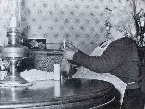 May Williams braiding nets at her cottage