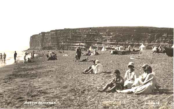 Tom Swaffield's boat amongst people enjoying themselves on the beach - and all dressed up too!  c1920's