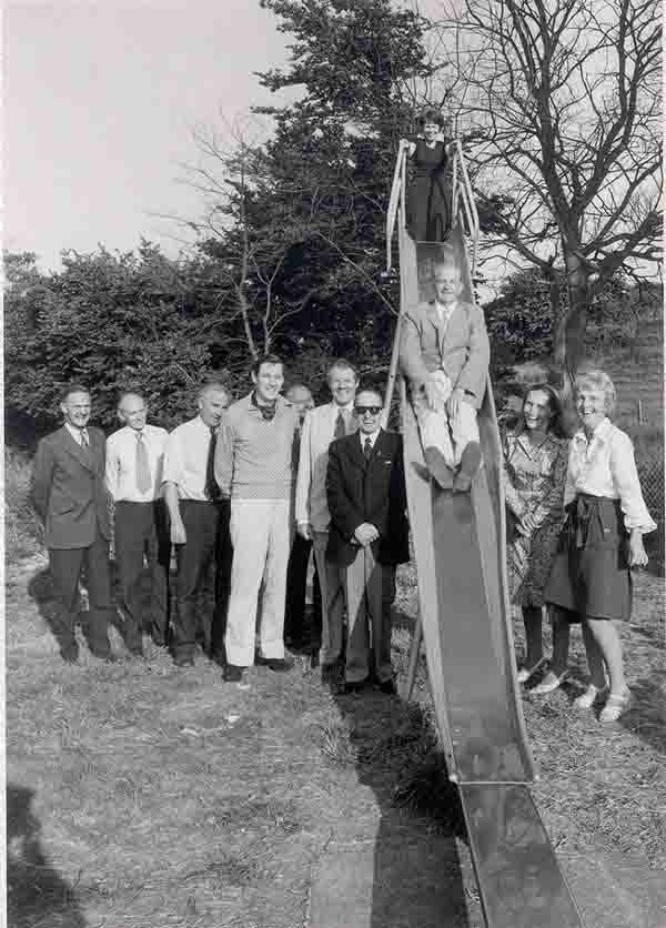 Burton Wives Group raised money for a new slide. Parish Council Chairman, Jack Burt) tries it out - 1976.