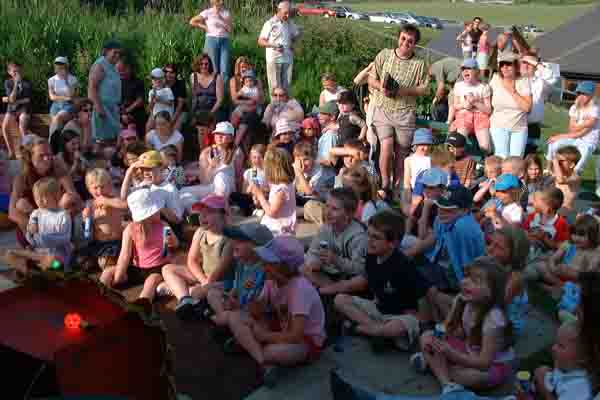 A large number of children watching Punch & Judy